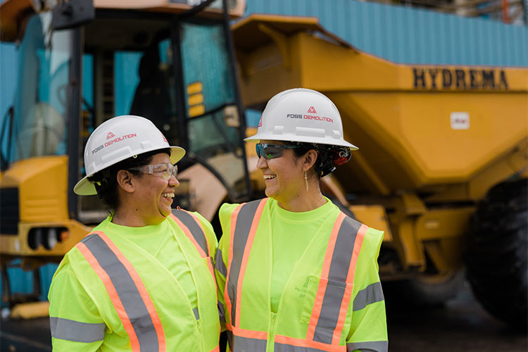 Two female construction workers in safety vests