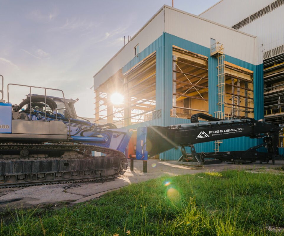 Sun shining through building with heavy equipment in foreground